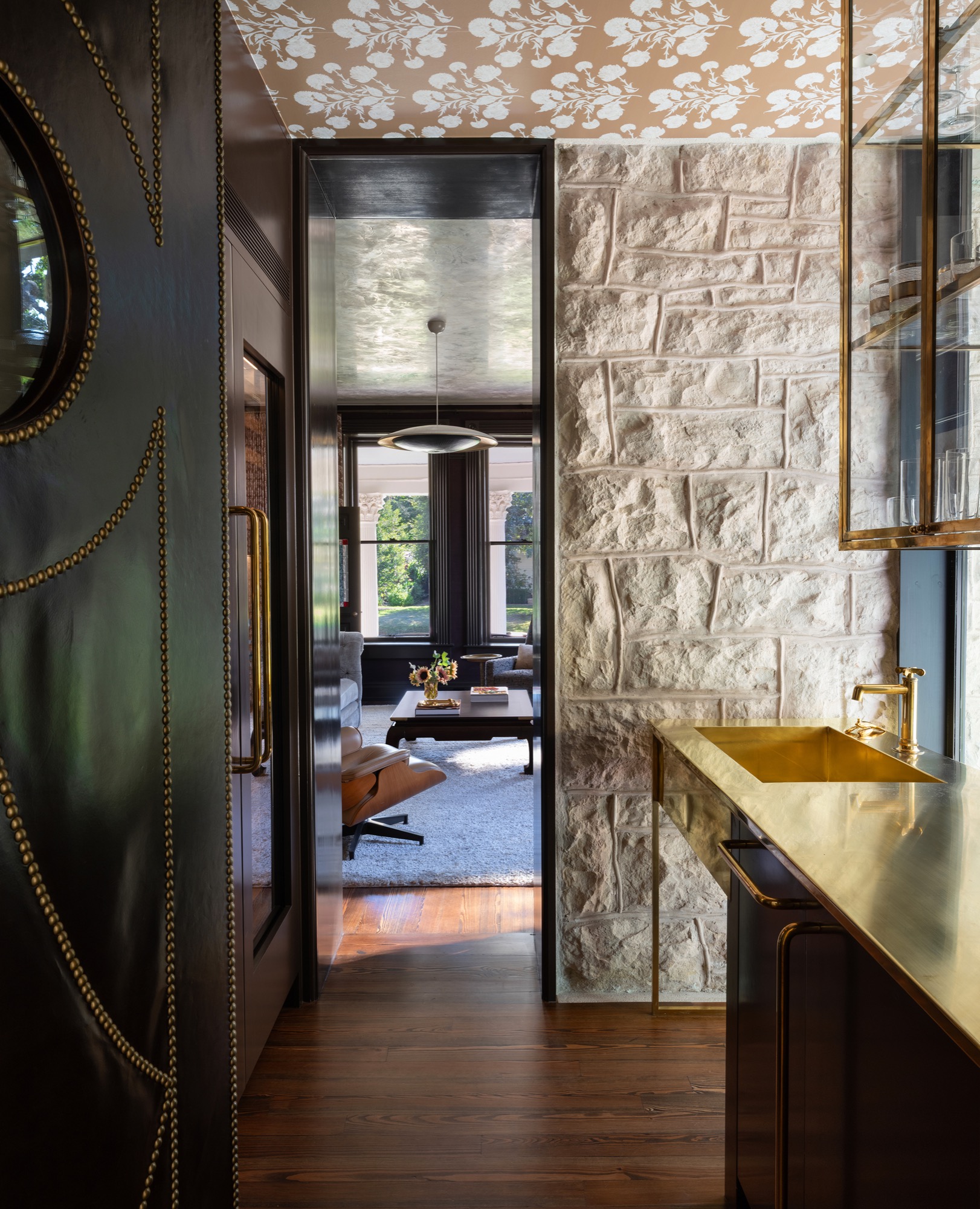 Victorian House bar with leather door and brass shelves in Austin, Texas